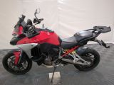 motorcycle parked on a black and white checkered floor with a red and black motorcycle
