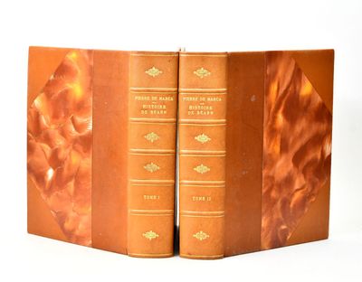 two books that are open on a white surface