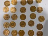 a lot of gold coins on a white surface