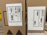 two boxes are stacked on top of each other on a table
