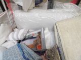 a pile of mattresses and blankets in a store
