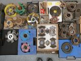 many different types of metal parts and tools on the floor