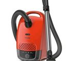 une image représentant un aspirateur rouge muni d'une poignée noire