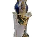 a vase with a bird sitting on top of it