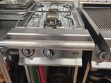 a stove with two burners on top of it in a kitchen