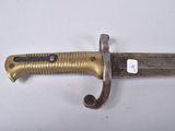 a close up of a knife on a white surface with a tag on it