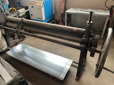 an image of a machine that is working on a piece of metal