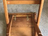 a wooden chair that is sitting on a carpeted floor