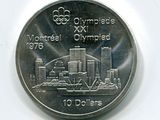 une pièce commémorative des Jeux Olympiques sur laquelle figure, en arrière-plan, l'image d'une ville