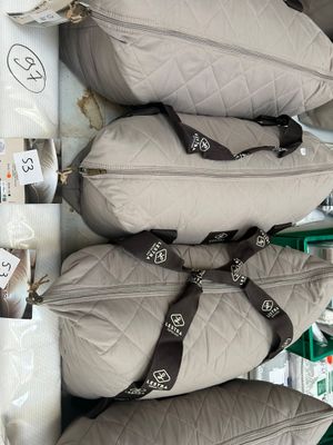 many bags of luggage that are stacked on top of each other