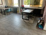une pièce avec un bureau, des chaises et une fenêtre