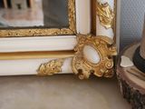 a mirror that is sitting on a table next to a vase