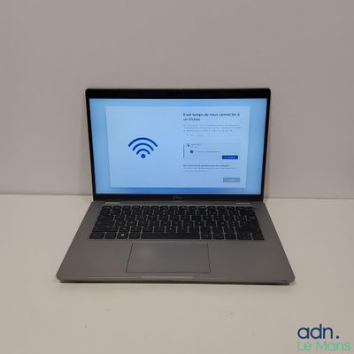 a laptop that is sitting on a table with a wifi sign on the screen