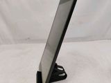 a close up of a tablet computer on a stand on a white surface