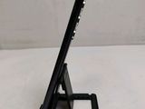a close up of a cell phone on a stand on a table