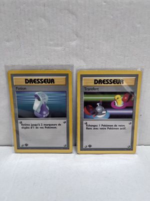 two pokemon cards sitting on top of each other on a table