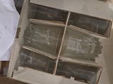 a box of empty wine glasses sitting on the floor