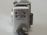 a silver camera with a cord attached to it