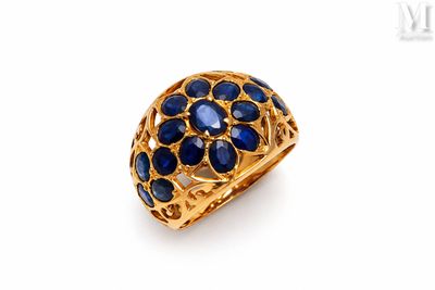 a close up of a gold ring with blue stones