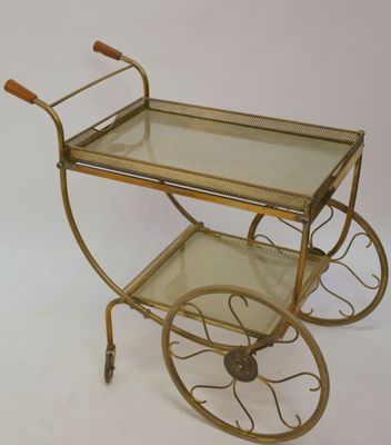 brass bar cart with glass shelves and wooden handles