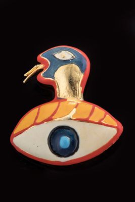 an image of a close up of a brooch with a bird on it