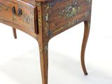 a small wooden table with a drawer on top of it