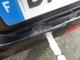 a close up of the bumper of a car that has been dented