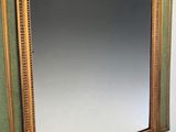 a mirror hanging on the wall next to a sink
