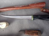 a knife, a knife holder, and a knife on a table