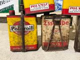 several old gas cans are lined up on a sidewalk