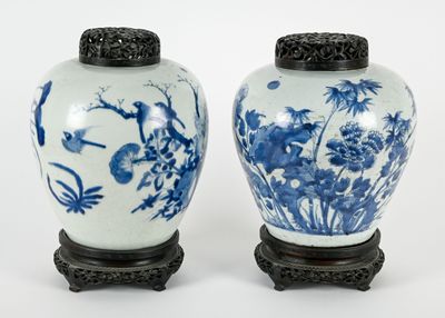 pair of blue and white vases with birds and flowers on them