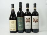four bottles of wine are lined up on a white surface