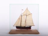 a small model of a sailboat in a glass case