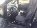 the interior of a car with the door open and the driver ' s seat up