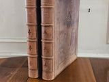 two books sitting on a wooden table next to each other