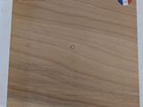 a close up of a piece of wood on a white surface