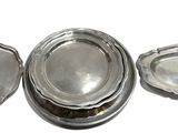 three silver plated dishes with lids on a white surface