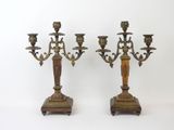 pair of antique brass candelabs on wooden bases