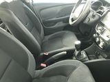 the interior of a car with black seats and steering controls