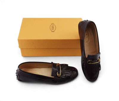 a close up of a pair of shoes with a box in the background