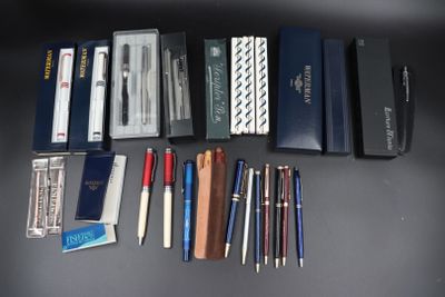 de nombreux stylos et crayons de toutes sortes disposés sur une table