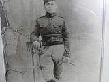 an old photo of a man in a military uniform holding a cane