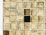 a square tile with a black square in the middle