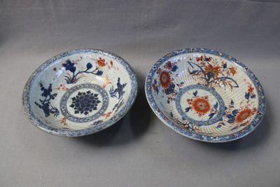 pair of blue and white plates with flowers and leaves on them
