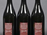 three bottles of wine sitting next to each other on a table