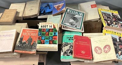 many books stacked on top of each other on a table