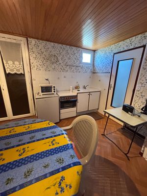 a small kitchen with a table and chairs in it