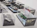 many different models of cars in display cases on a table