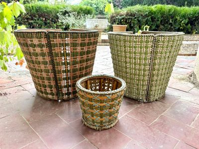 three baskets that are sitting on the ground next to each other