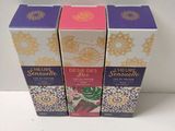 three boxes of perfume sitting on top of a white table